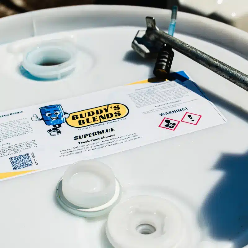 Buddy's Blends SUPERBLUE truck fleet cleaner top of the drum with a drum wrench